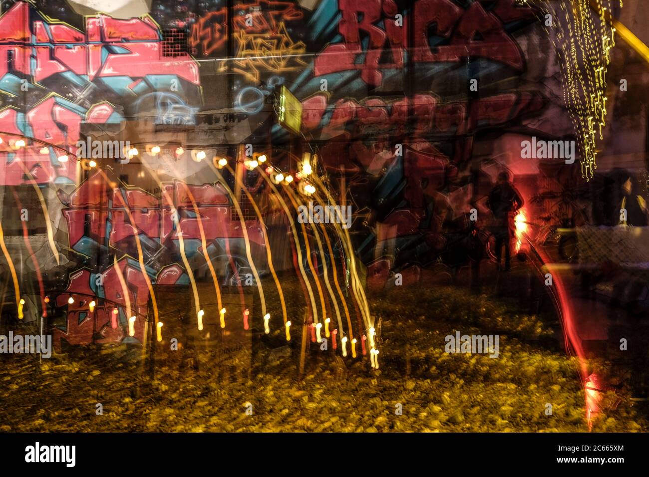 Colorful blurred lights in front of a graffiti wall, Munich, Bavaria, Germany Stock Photo