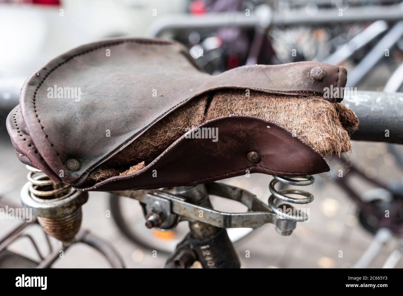 Old bicycle with broken saddle, close-up, detail Stock Photo