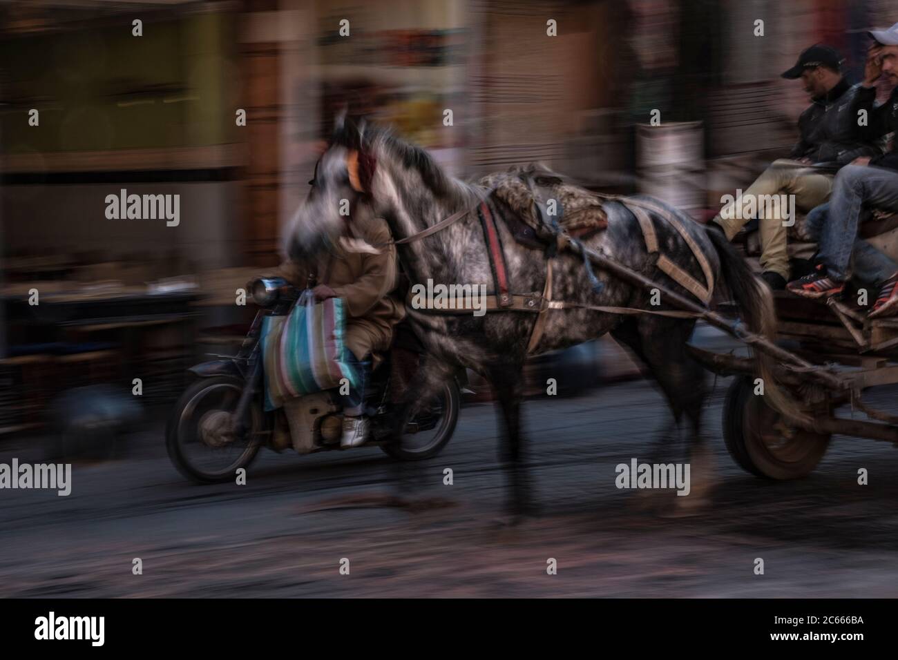 Horse carriage racing through a souk, Marrakech, Morocco Stock Photo