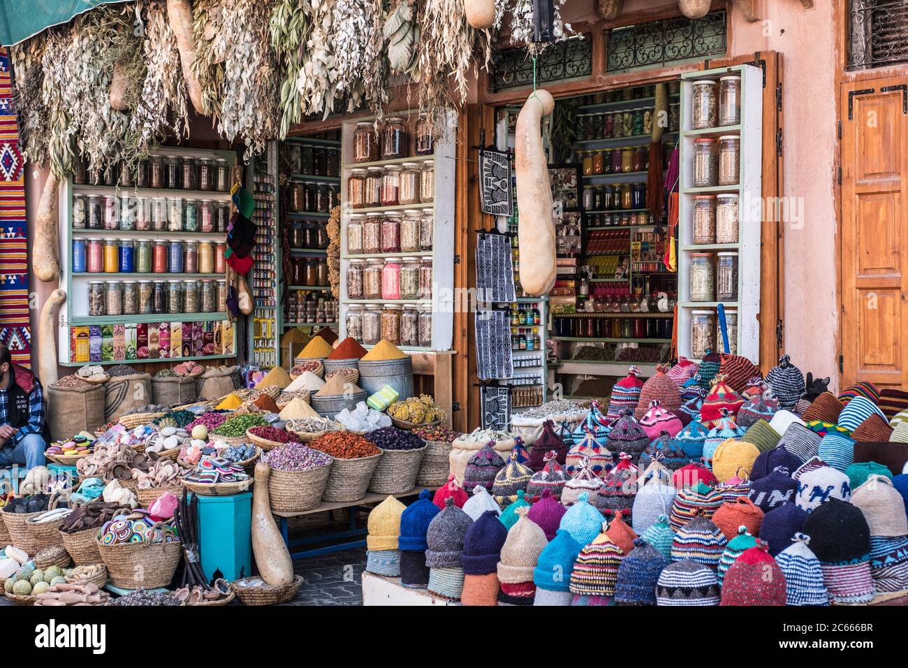 Handknitted caps and spices in a souk in Marrakech, Morocco Stock Photo