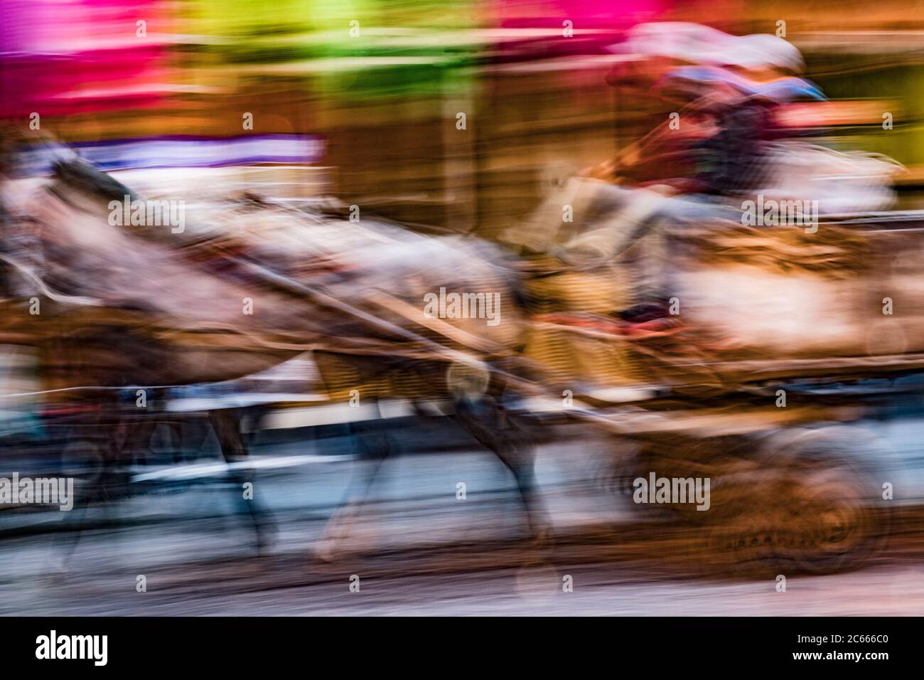 Horse carriage racing through a souk, Marrakech, Morocco Stock Photo
