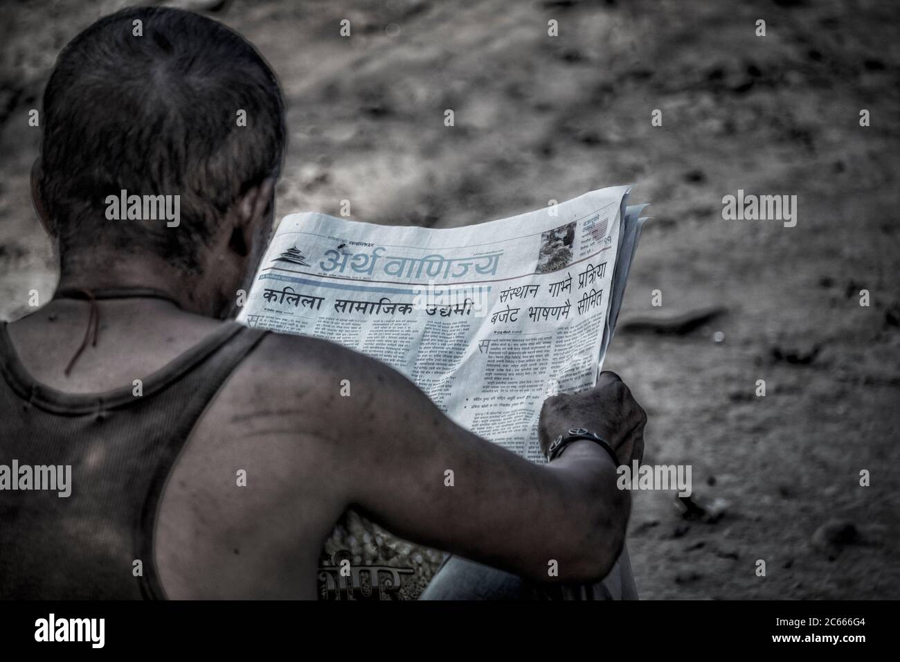 Man reads newspaper in Kathmandu, Nepal Stock Photo