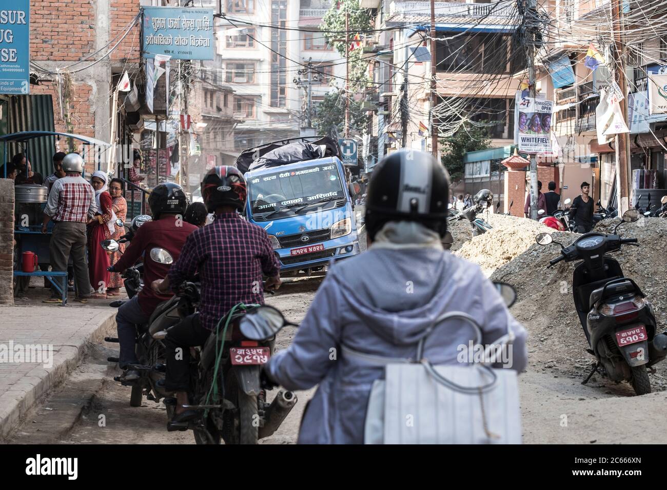 Moped rider in a street in Kathmandu, Nepal Stock Photo