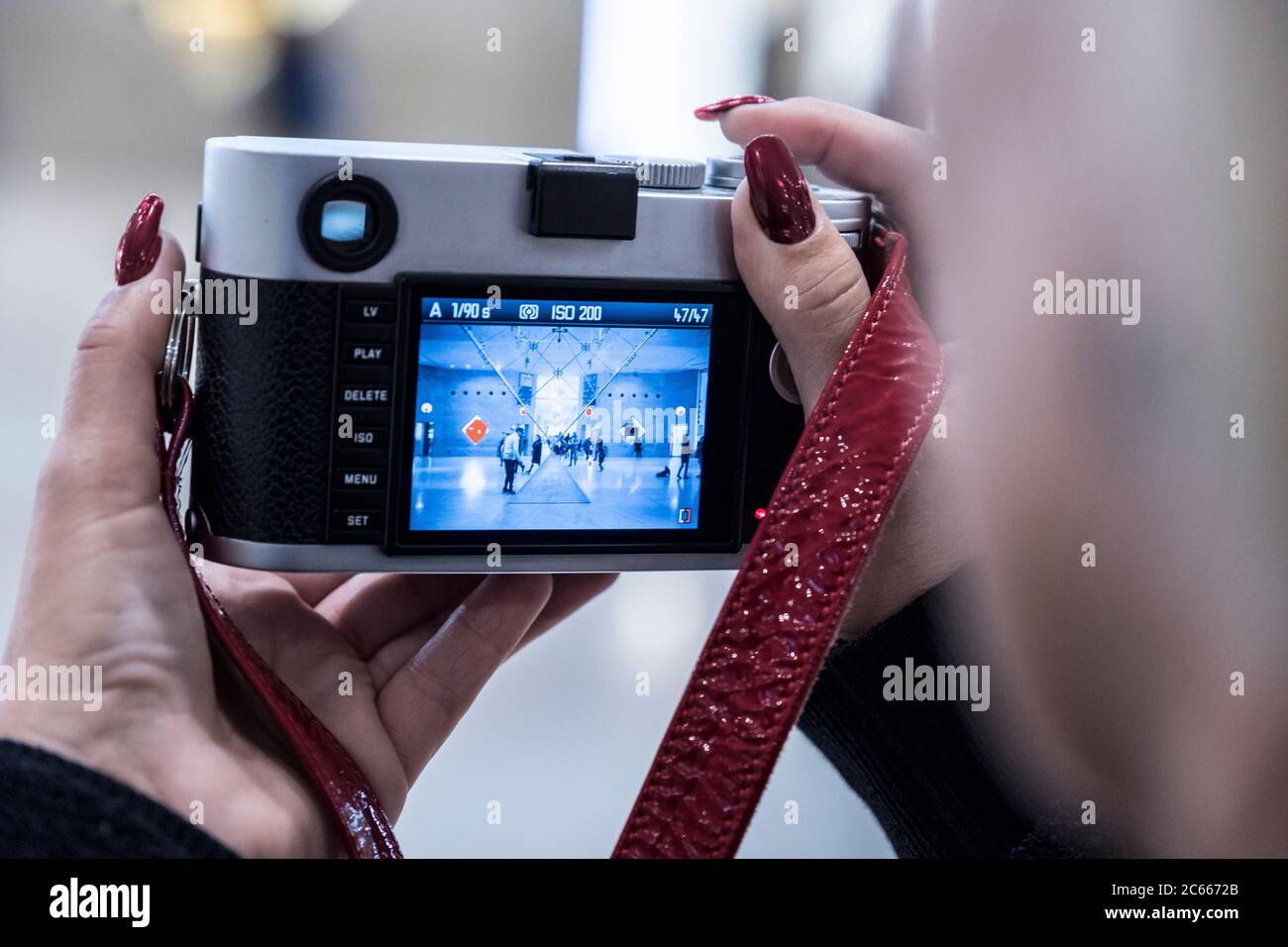 Woman photographed with a digital camera in the Louvre, Paris, France Stock Photo