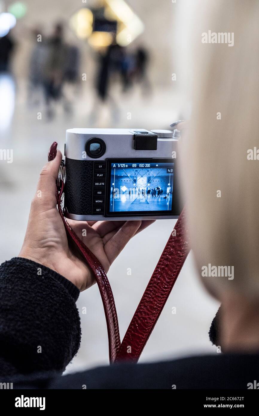 Woman photographed with a digital camera in the Louvre, Paris, France Stock Photo
