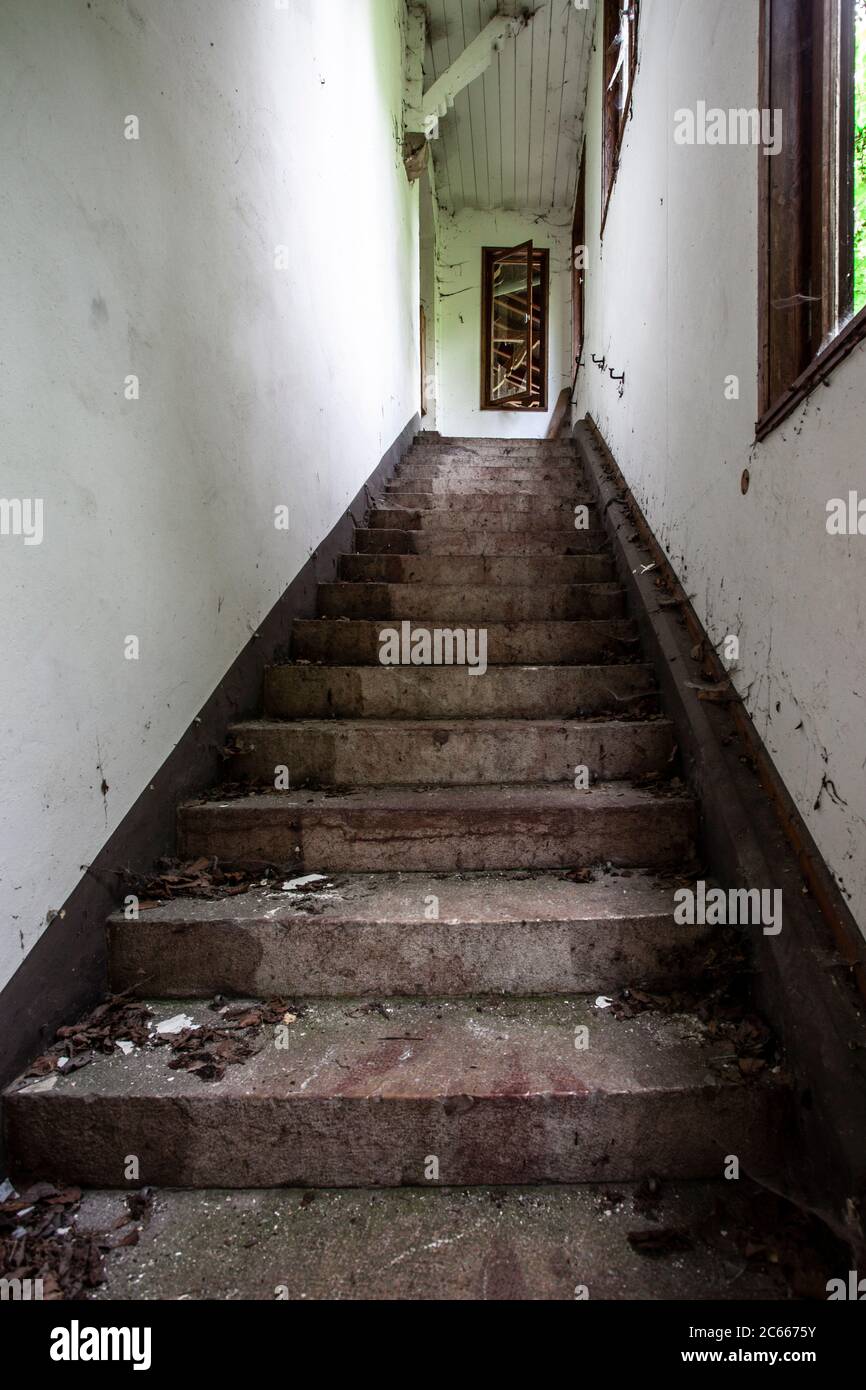 Stairwell of an old abandoned hotel Stock Photo