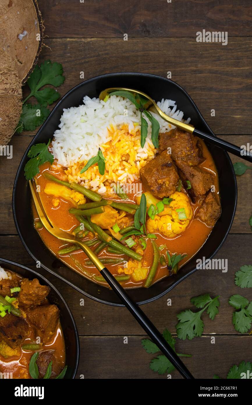 Vegan Thai red curry with seitan, beans and cauliflower over rice