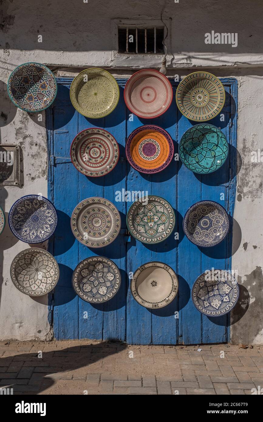 Colorful plate at a blue door in Essaouira Stock Photo