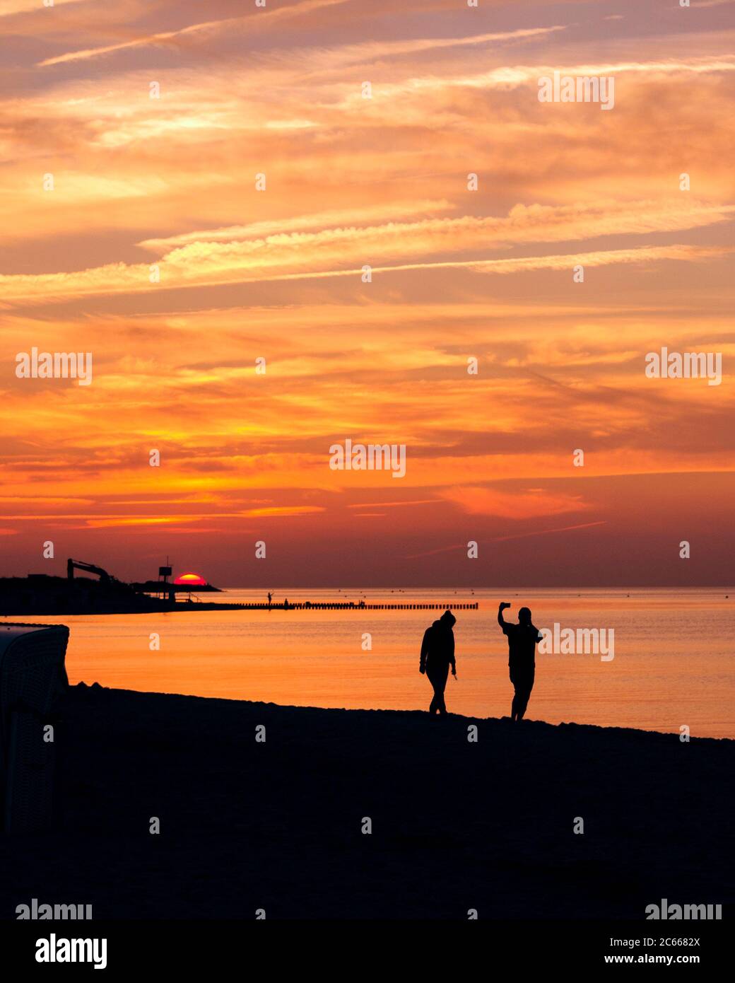 Couple on the beach at sunset, photographed, selfie, silhouettes Stock Photo