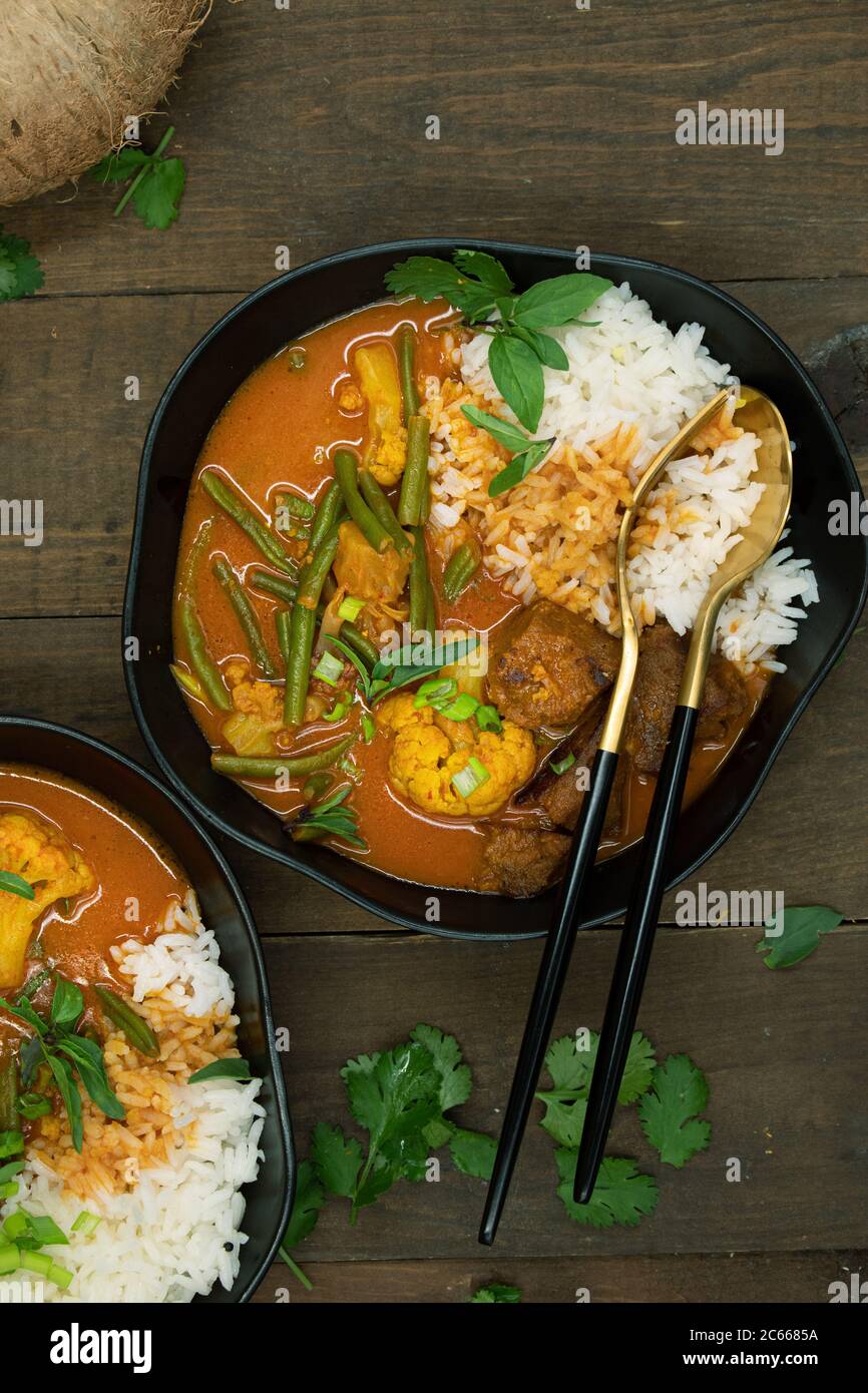 Vegan Thai red curry with seitan, beans and cauliflower over rice