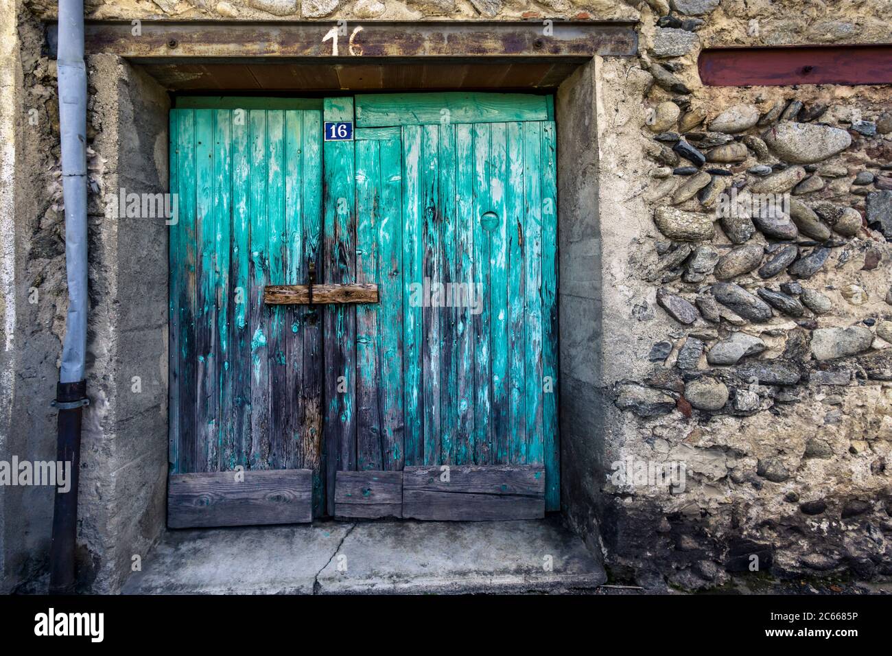 Old wooden gate in turquoise in Ille sur Têt Stock Photo