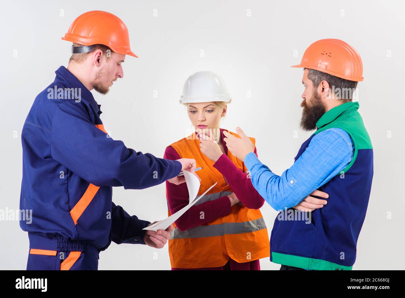 Men in hard hats, uniform and woman. Team of architects, engineers ...