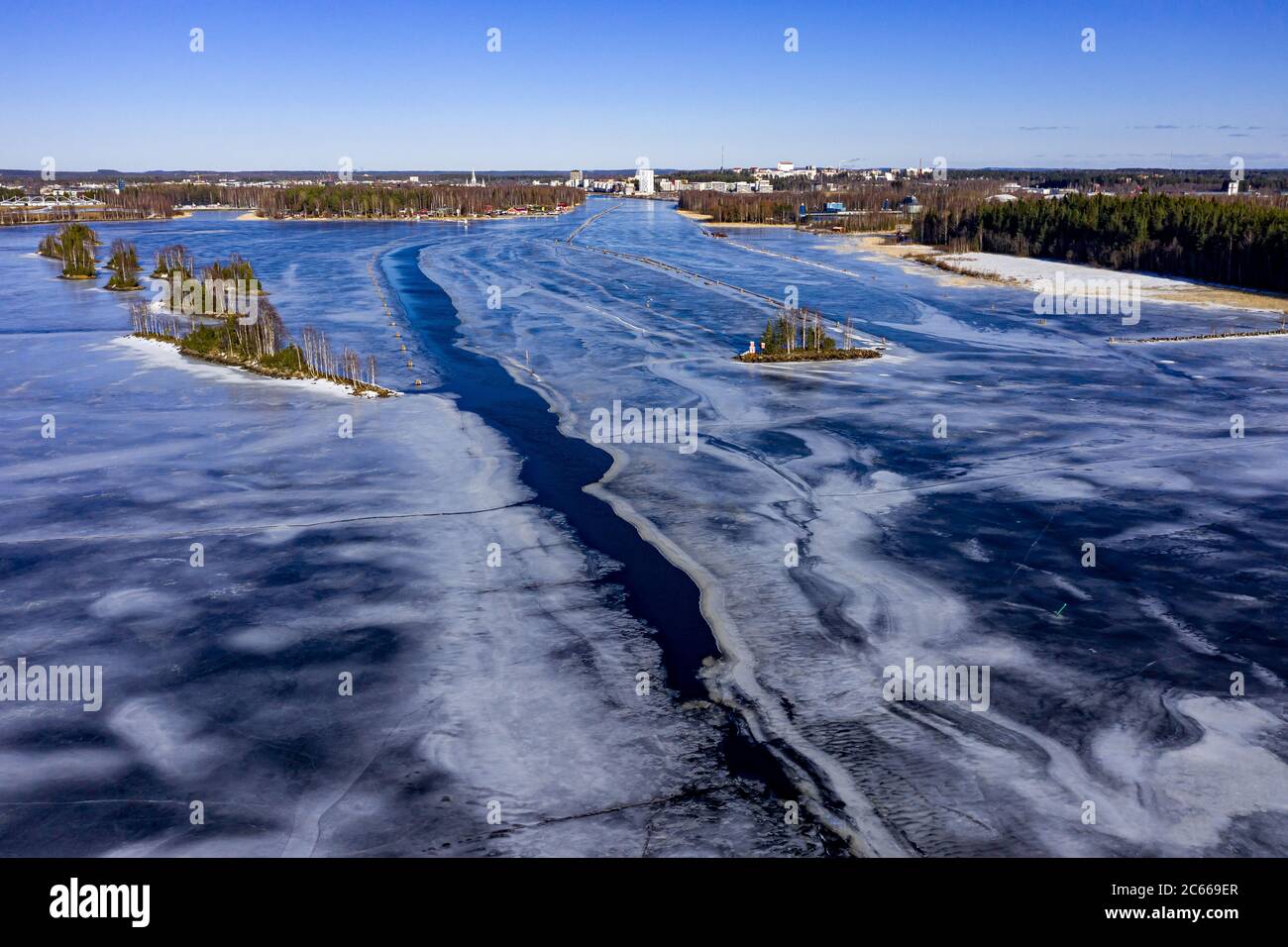 Aerial view of the Pielisjoki river near the Joensuu city. Ice-covered river in spring. Stock Photo
