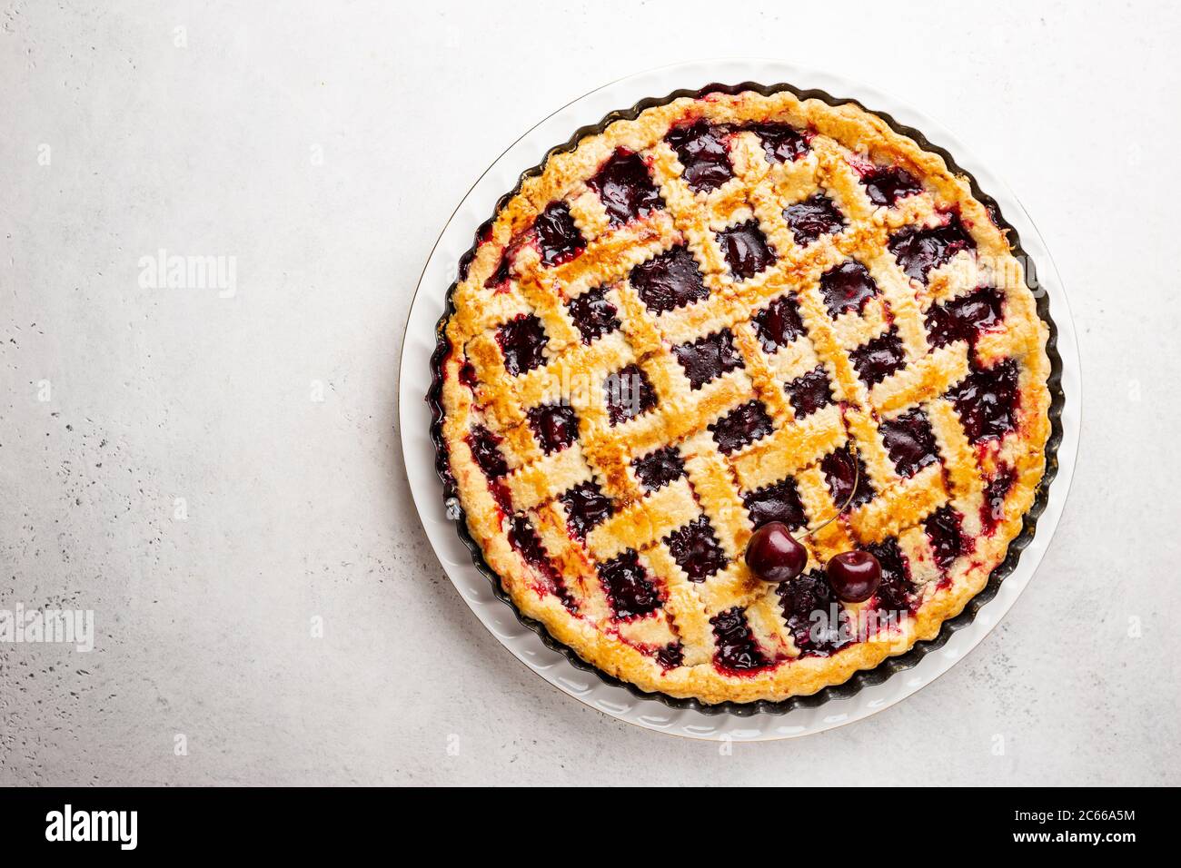 Delicious homemade classic cherry pie with a flaky crust on white ...