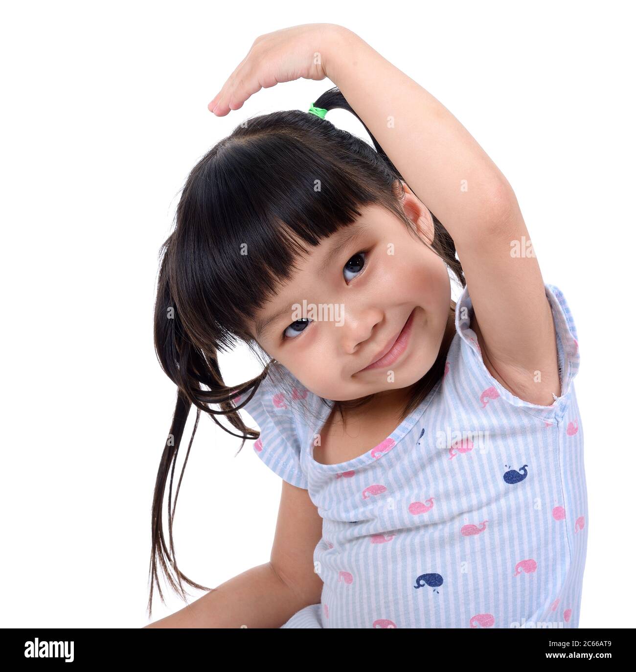 Little girl hold her hand above a head isolated on white background ...