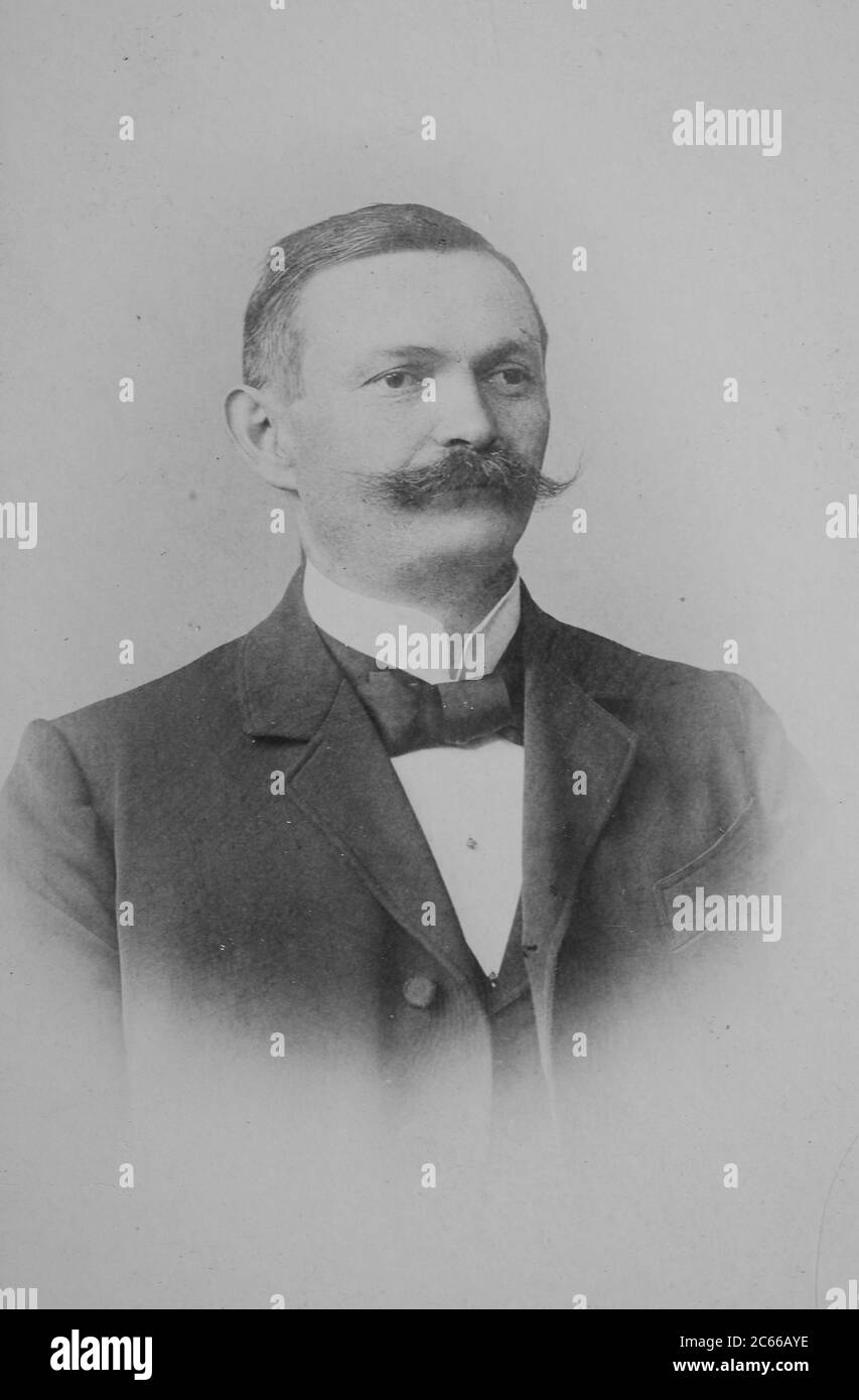 Man with a mustache, a suit and bow tie, elegant, 1890, Berlin, Germany  /  Mann mit Schnurrbart, Anzug und Fliege, elegant, 1890, Berlin, Deutschland, Historisch, historical, digital improved reproduction of an original from the 19th century / digitale Reproduktion einer Originalvorlage aus dem 19. Jahrhundert, Carte de visite, a type of small photograph which was patented in 1854, each photograph was the size of a visiting card, and such photograph cards were commonly traded among friends and visitors in the 1860s  /  Visitformat, Carte de Visite, auf Karton fixierte Fotografie im Format ab Stock Photo