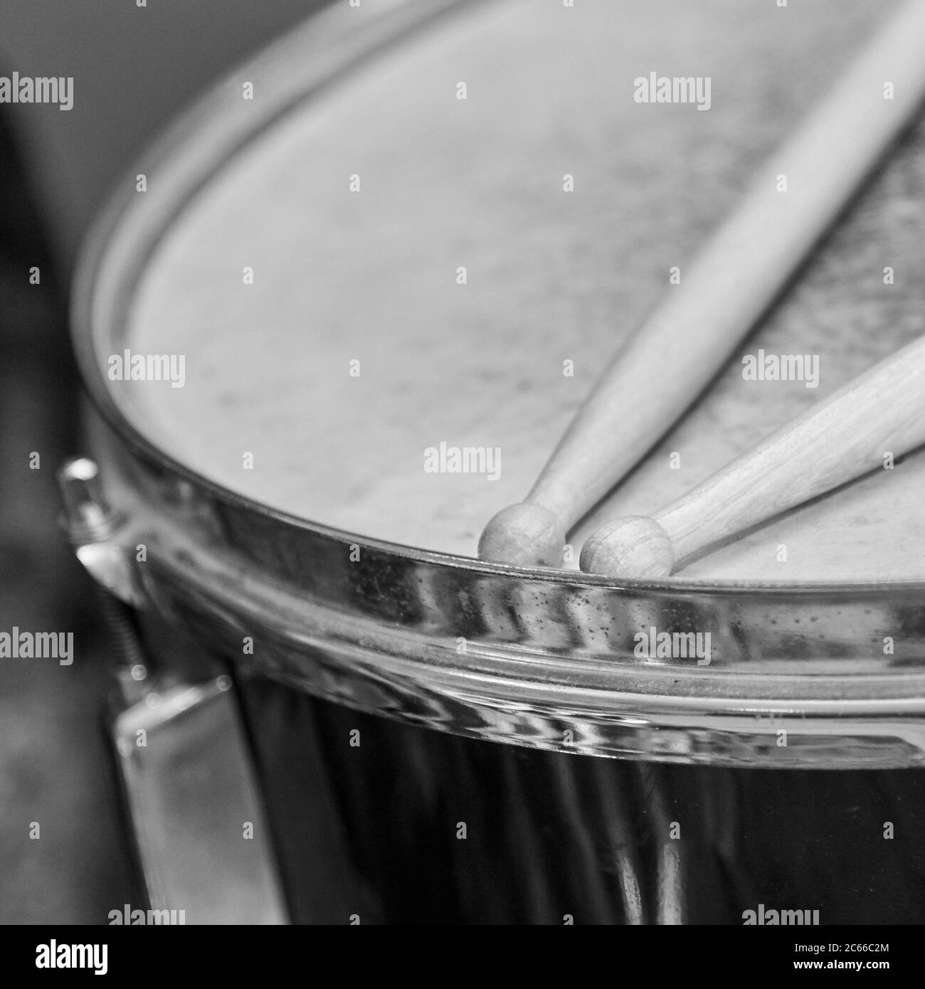 Two wooden drumsticks lie on the drum, black and white photo Stock ...