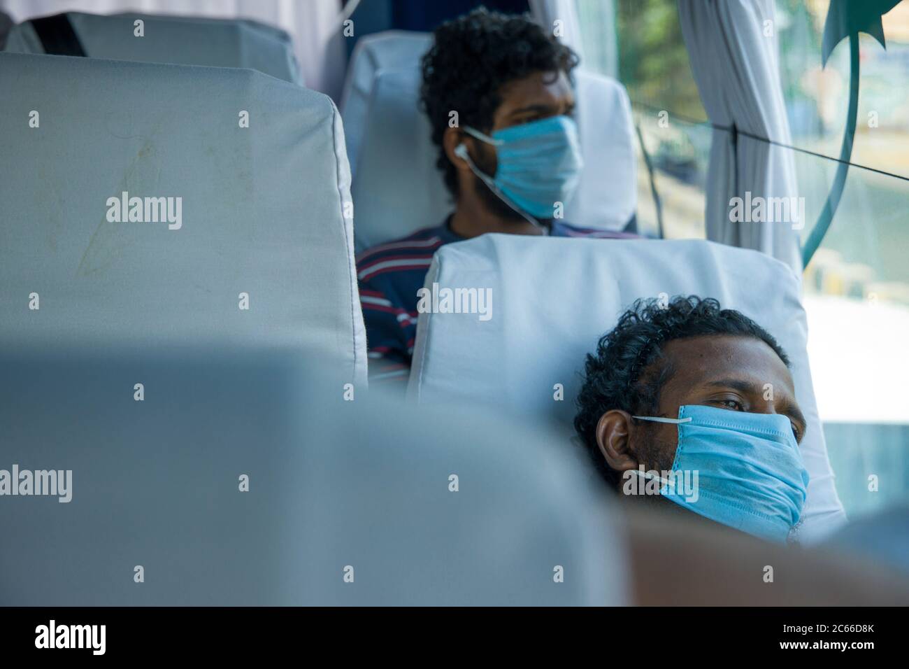 People travelling by bus to their native places during spread of pandamic disease Covid-19 Stock Photo