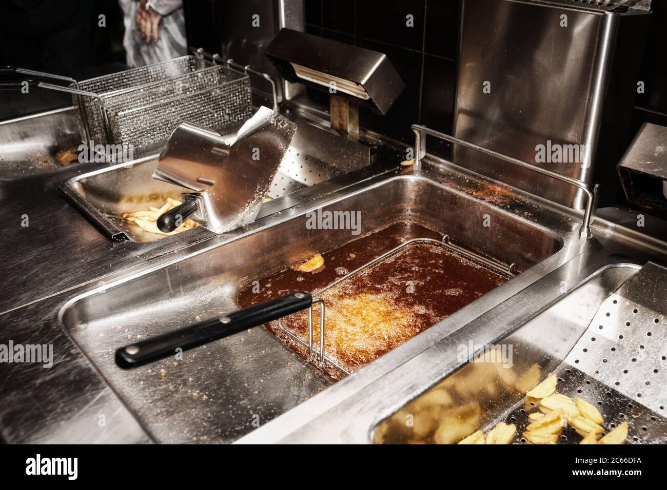 Deep fryer with boiling oil in commercial kitchen, fast food restaurant
