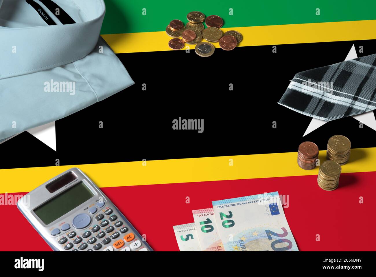 Saint Kitts And Nevis flag on minimal money concept table. Coins and