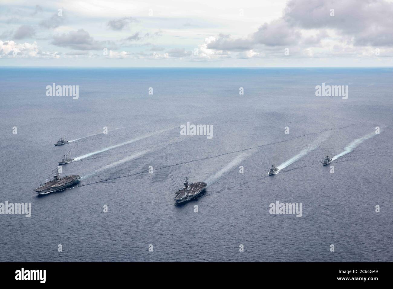 The U.S. Navy Nimitz-class aircraft carriers USS Ronald Reagan and USS Nimitz along with their Carrier Strike Groups steam in formation during dual-carrier operations July 6, 2020 in the South China Sea. Stock Photo