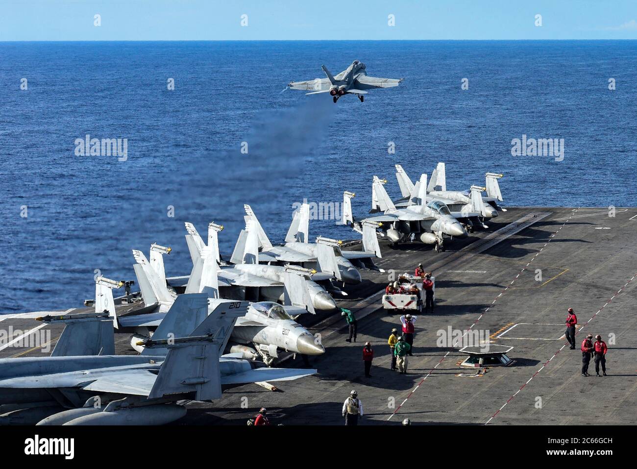 A U.S. Navy F/A-18E Super Hornet fighter aircraft, from the Eagles of Strike Fighter Squadron 115, launches from the flight deck of the Nimitz-class aircraft carrier USS Ronald Reagan during dual-carrier operations July 5, 2020 in the South China Sea. Stock Photo