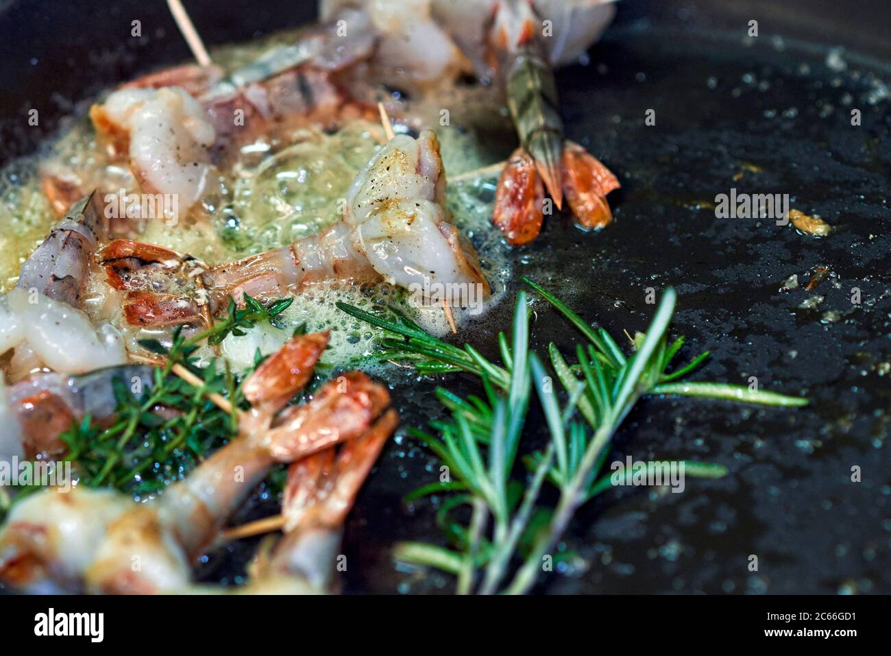 Preparation of king prawns in a non-stick pan Stock Photo