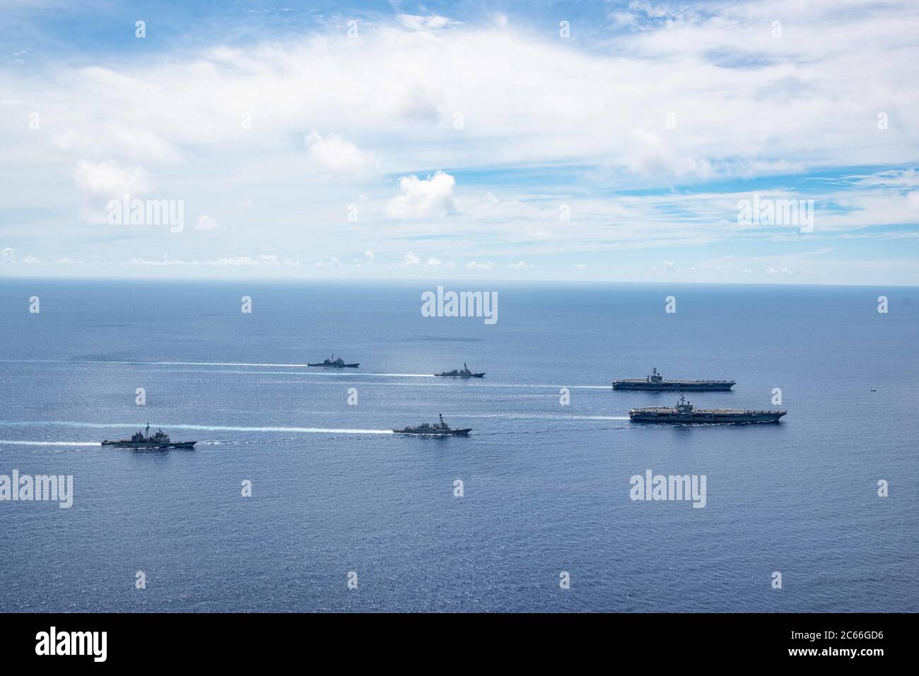 The U.S. Navy Nimitz-class aircraft carriers USS Ronald Reagan and USS Nimitz along with their Carrier Strike Groups steam in formation during dual-carrier operations July 6, 2020 in the South China Sea. Stock Photo