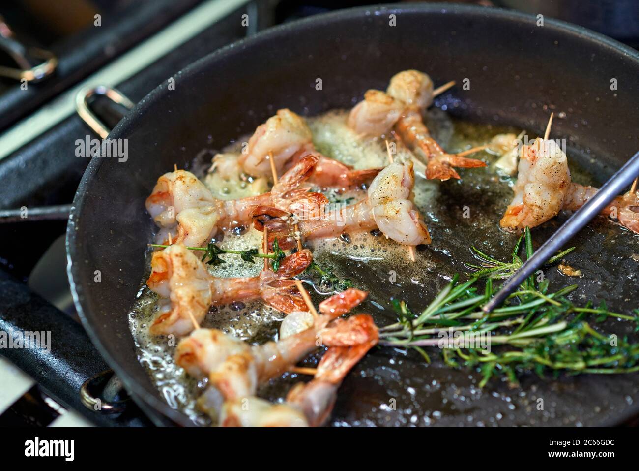 Preparation of king prawns in a non-stick pan Stock Photo