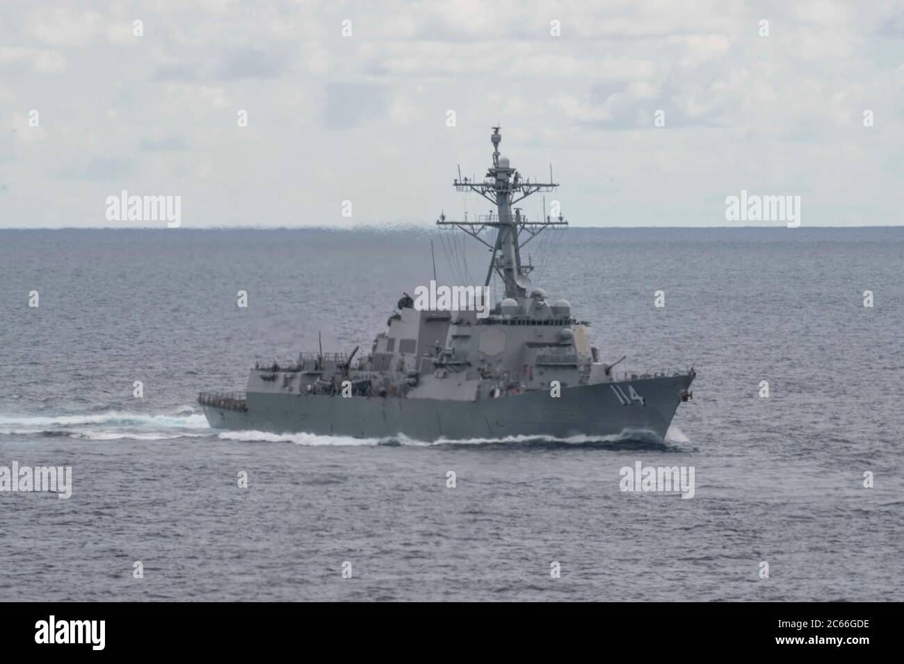 The U.S. Navy Arleigh Burke-class guided missile destroyer USS Ralph Johnson sails in formation during dual-carrier operations July 6, 2020 in the South China Sea. Stock Photo