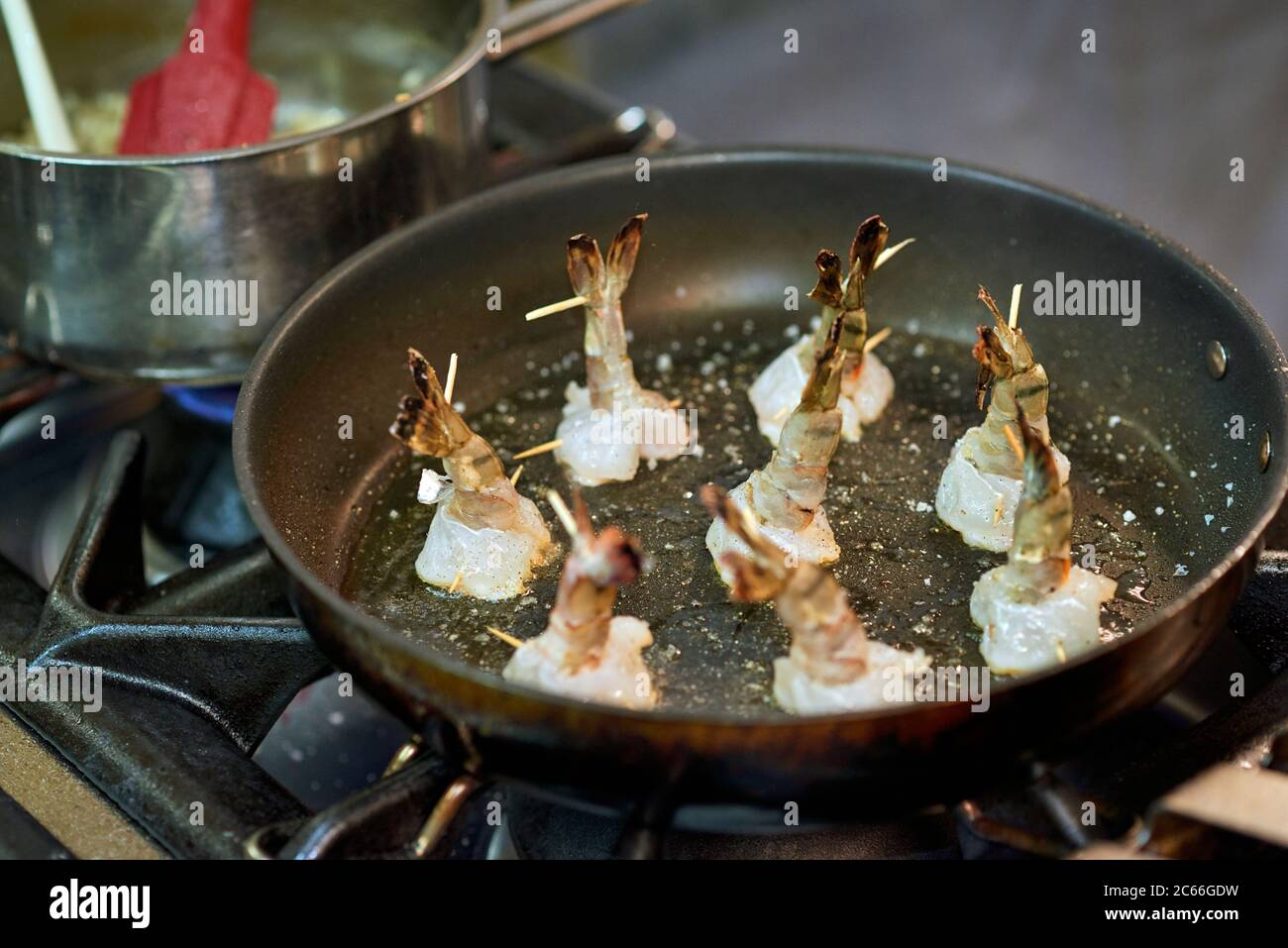 Preparation of king prawns in a non-stick pan Stock Photo