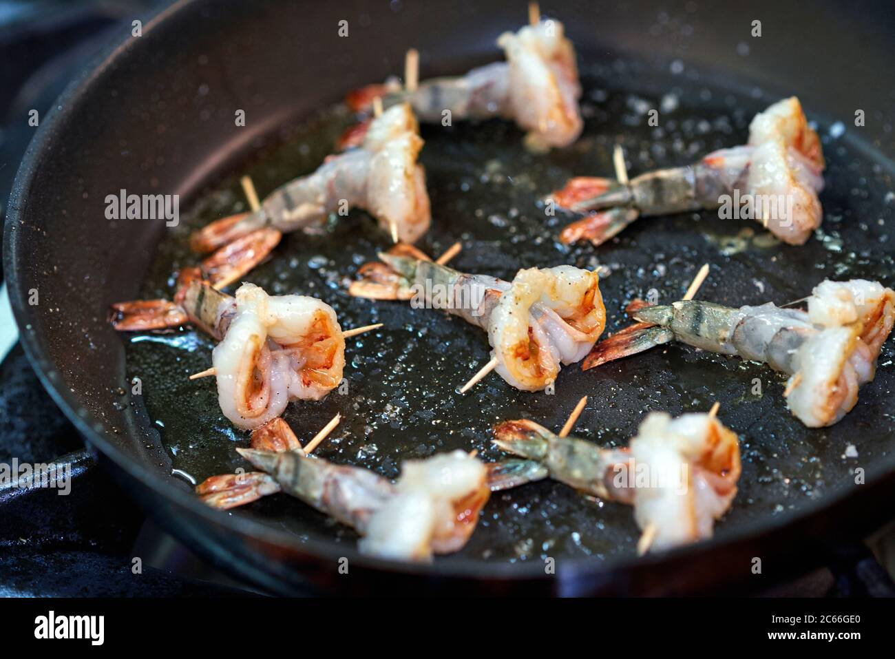 Preparation of king prawns in a non-stick pan Stock Photo