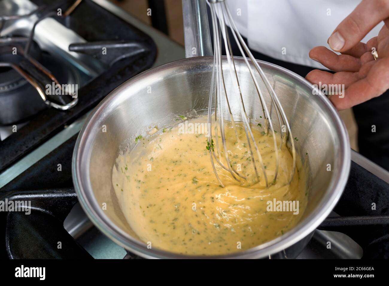 Preparation of Béarnaise Sauce step by step, chervil being added to the sauce Stock Photo