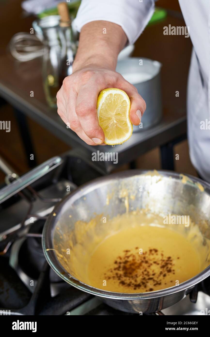 Preparation of Béarnaise Sauce step by step, seasoning, squeezed lemon being added Stock Photo