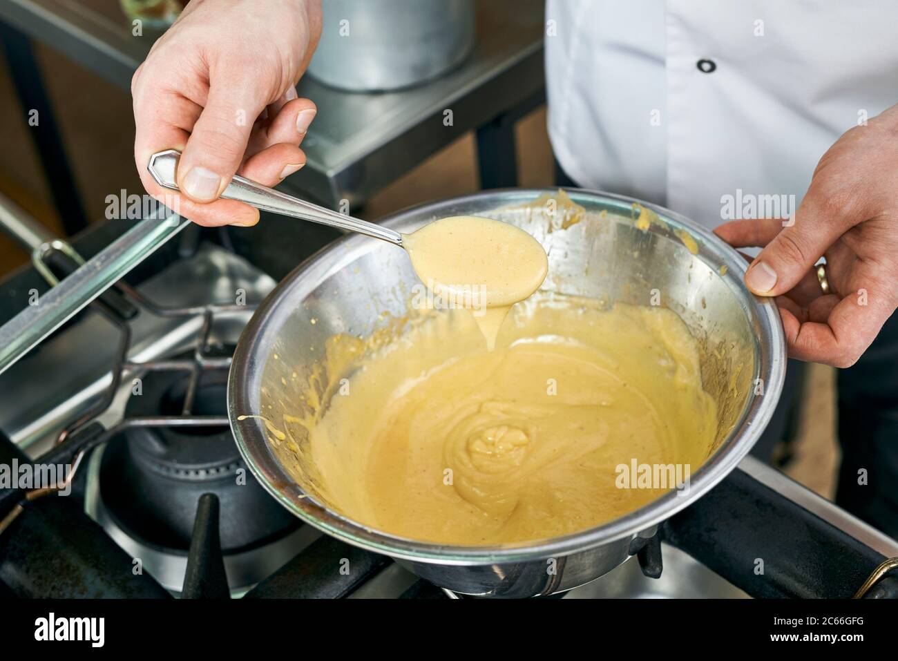 Preparation of Béarnaise Sauce step by step,  texture being checked Stock Photo