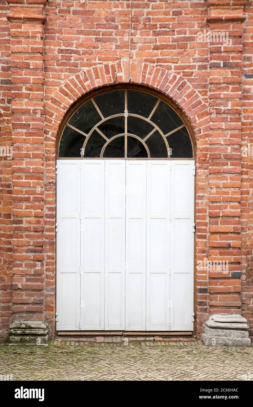 Door on the red brick wall old building Stock Photo - Alamy