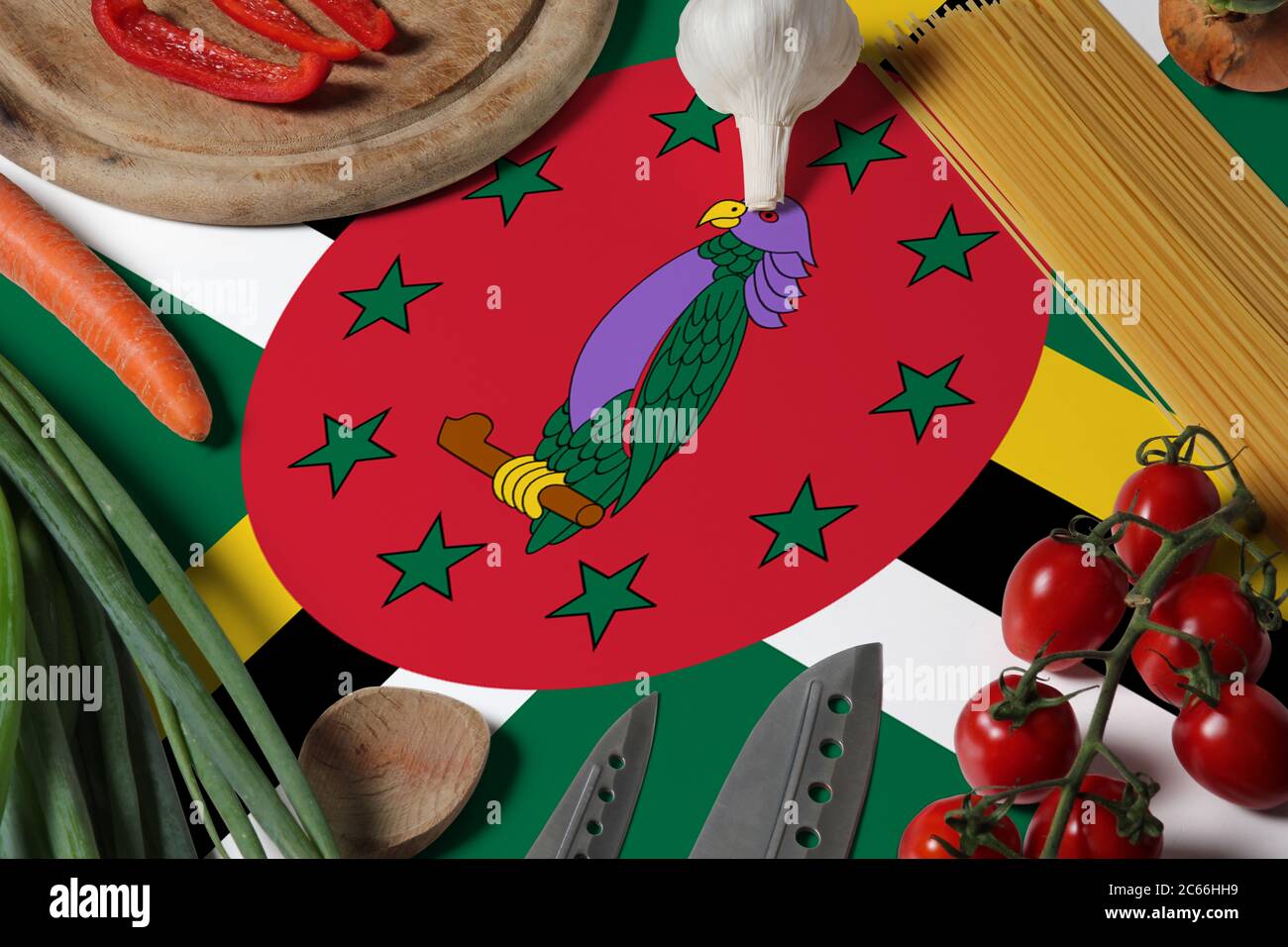 Dominica flag on fresh vegetables and knife concept wooden table. Cooking concept with preparing background theme. Stock Photo