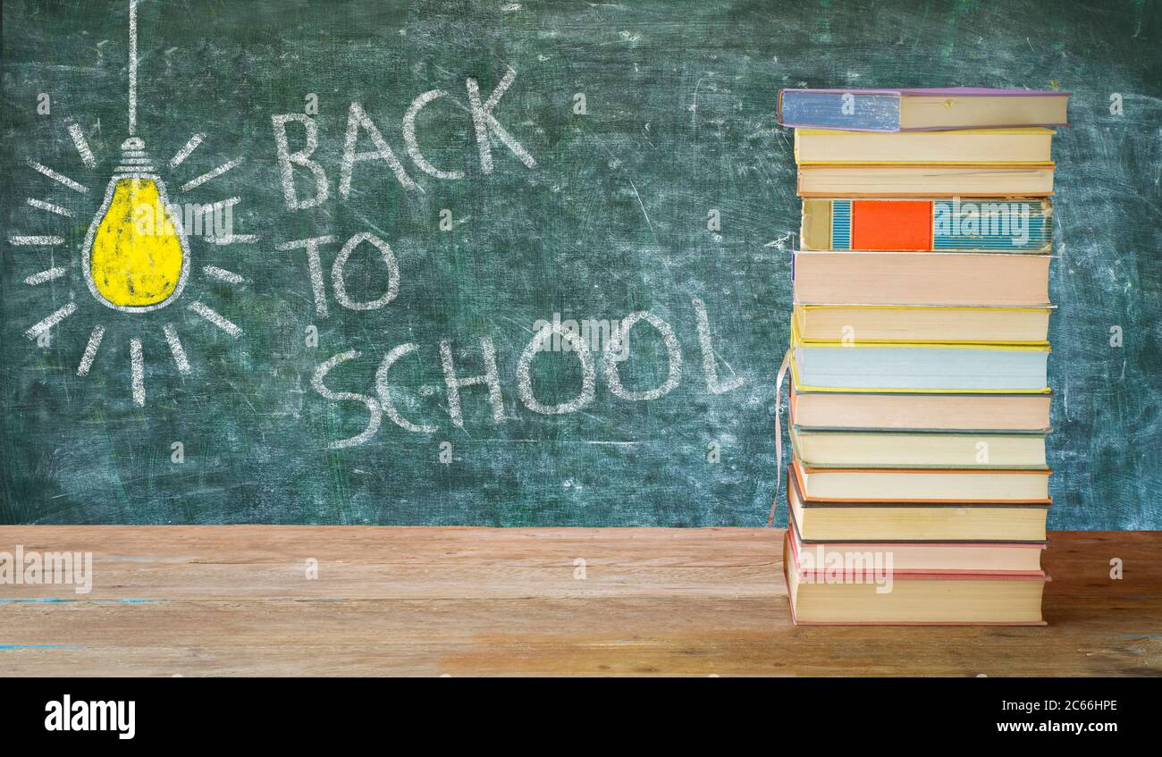 Back to school lettering, stacks of books, black board. Advanced training, on-the-job training; education,school, achievement concept with good copy s Stock Photo
