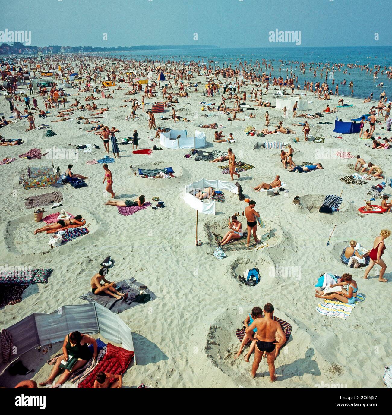 Summer vacationers relaxing on the wide sandy beach of Warnemünde on the Baltic Sea Stock Photo