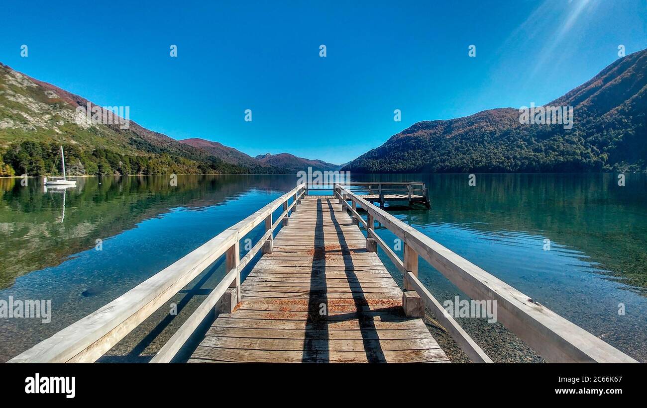 Footbridge on Lake Hermoso, surrounded by mountains, Argentina Stock Photo