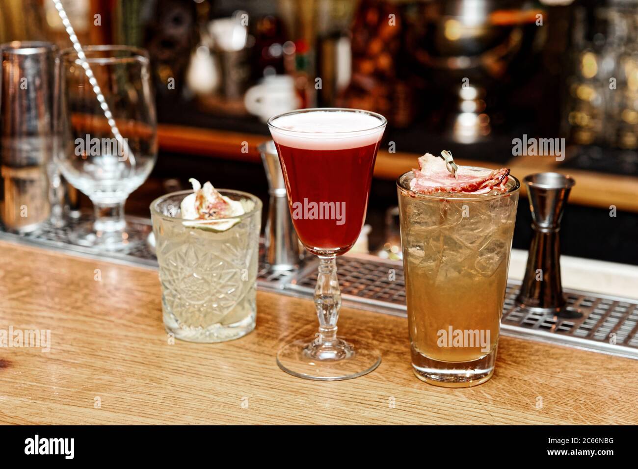 Three different cocktails served on bar counter, toned Stock Photo Alamy