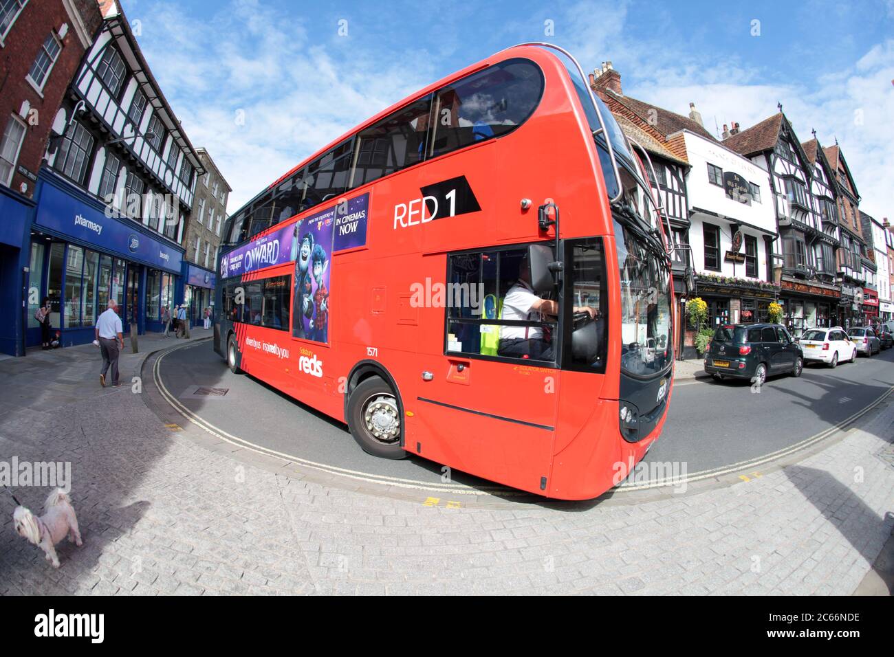A large red double decker bus navigates the narrow streets of Salisbury, Wiltshire UK. July 2020. Stock Photo