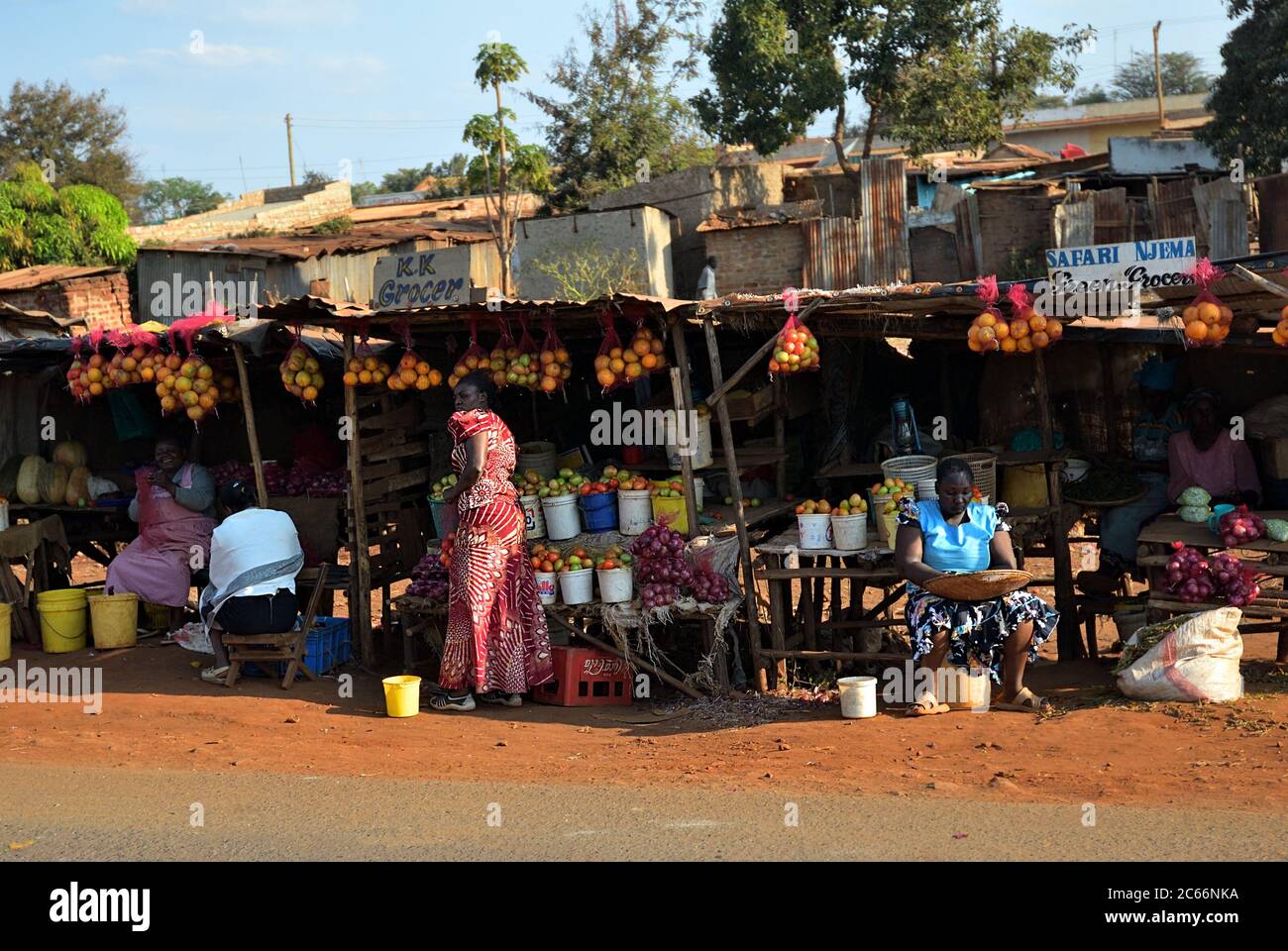 Kenya, Africa - August 22, 2010: Local people sell a farmer product and other goods on the rural market in slum along the road nearby Nairobi Stock Photo