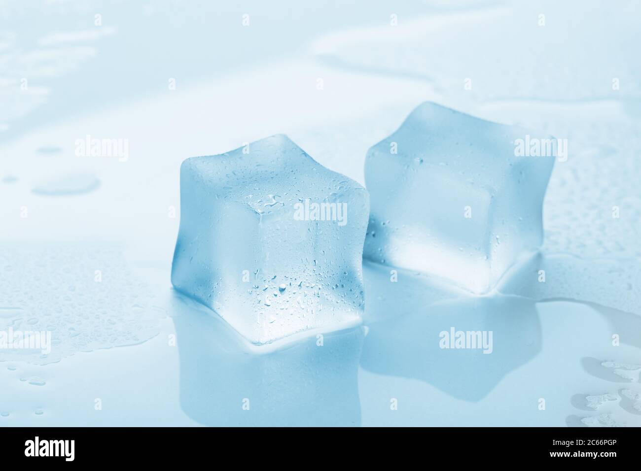 Melting frozen ice cubes illuminated with blue coloured LED light in the  dark Stock Photo - Alamy