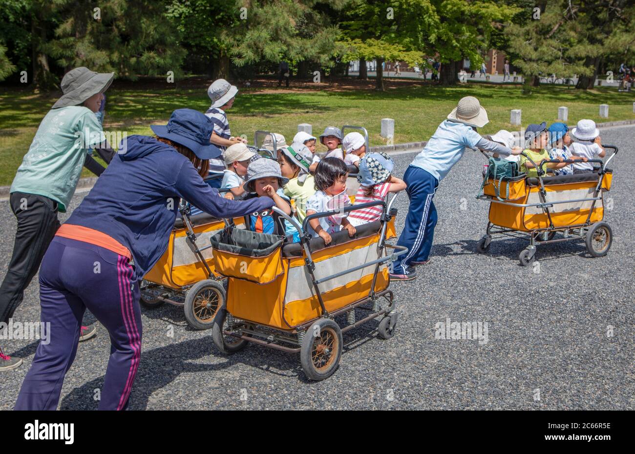 Japan, Kyoto City, Children caretakers transporting Stock Photo