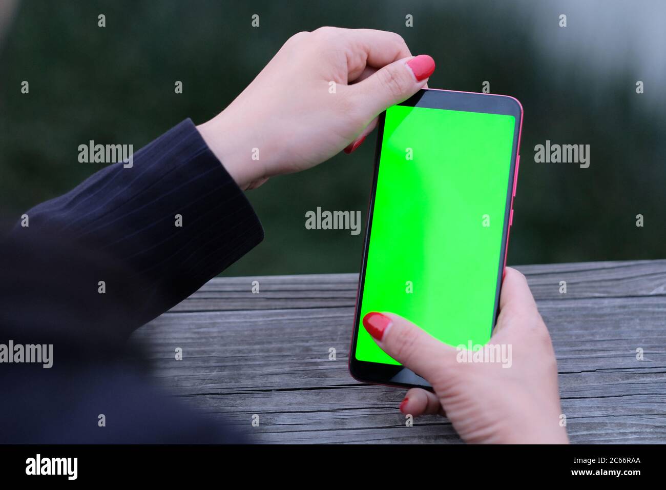 business woman using green screen smartphone. Blur background Stock Photo