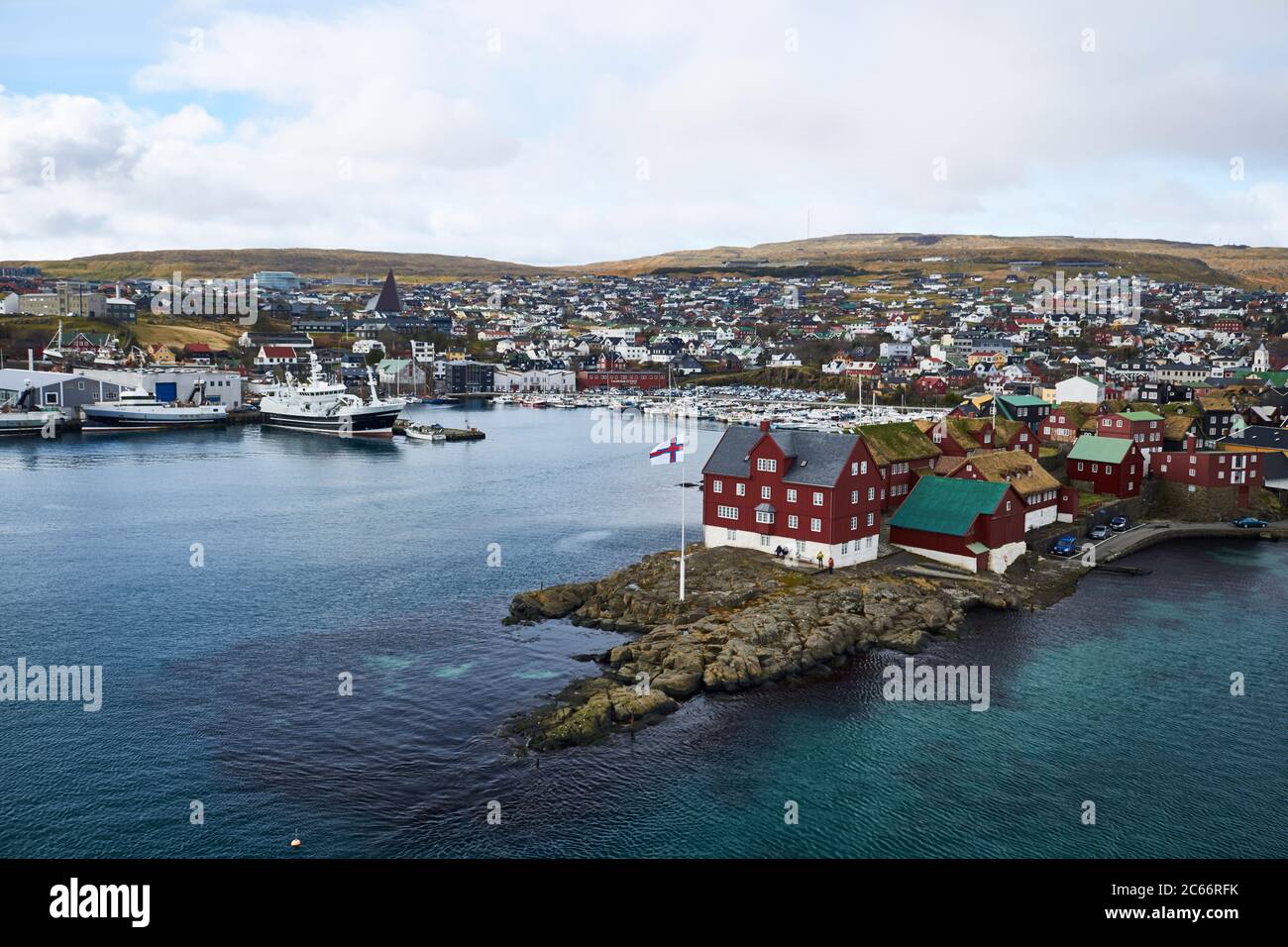 Faroe Islands, View of little Harbour Town, snowcapped mountain in the background Stock Photo