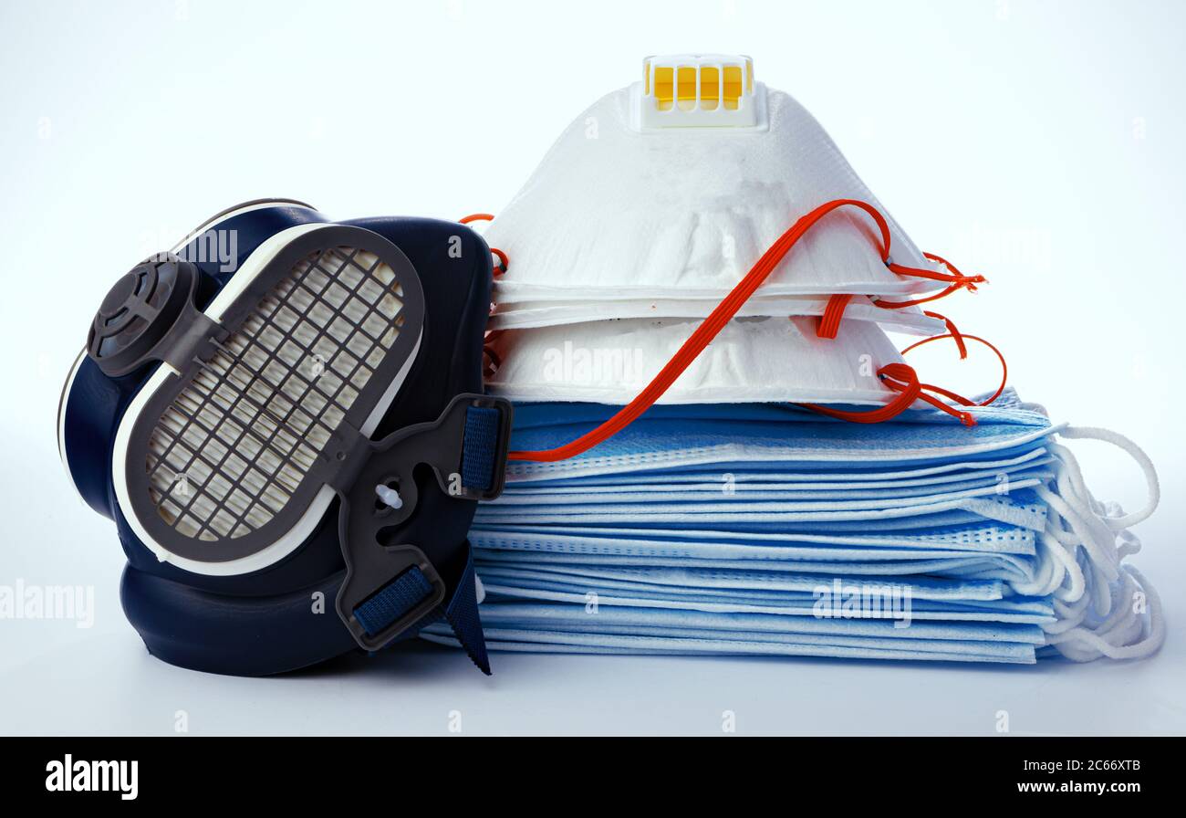 Stack of medical masks with respirator on white background Stock Photo ...
