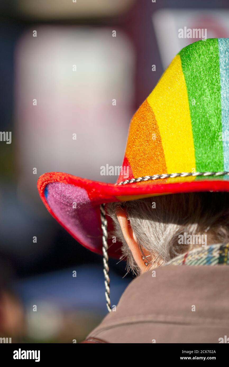 Elderly woman wearing a rainbow coloured Stetson hat, during the women's march on London, January 2017 Stock Photo