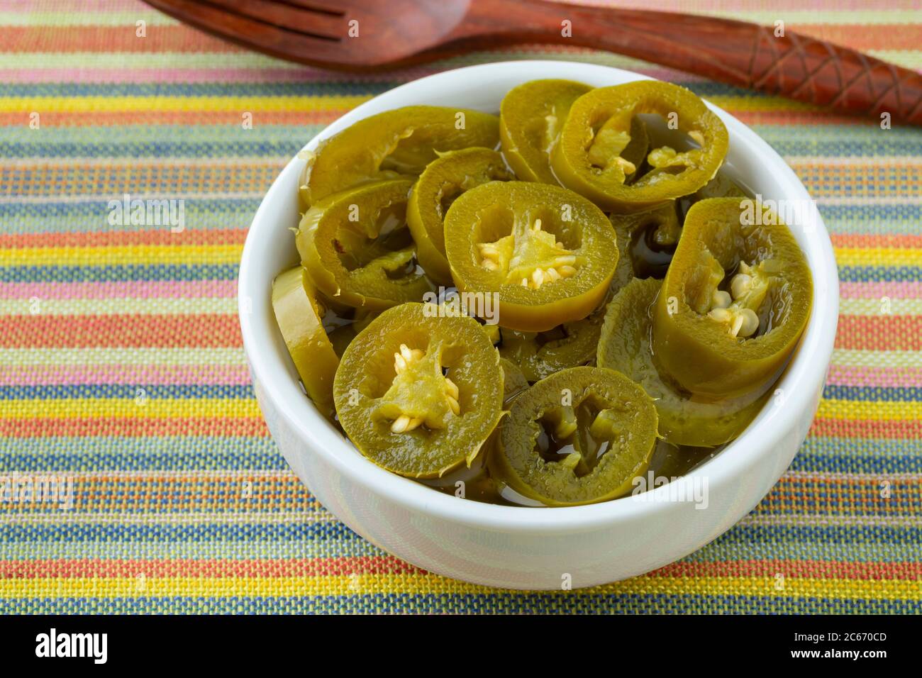 Bowl with sliced pickled jalapeno peppers Stock Photo